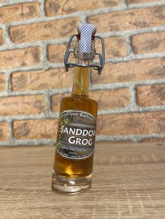 Kleine Flasche Sanddorn Grog Bounty 40 ml vor Backsteinwand